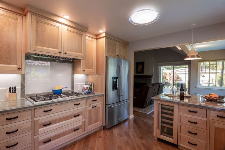 Kitchen with stone countertops and a full stone island, fabricated and installed by Roman Marble Shop