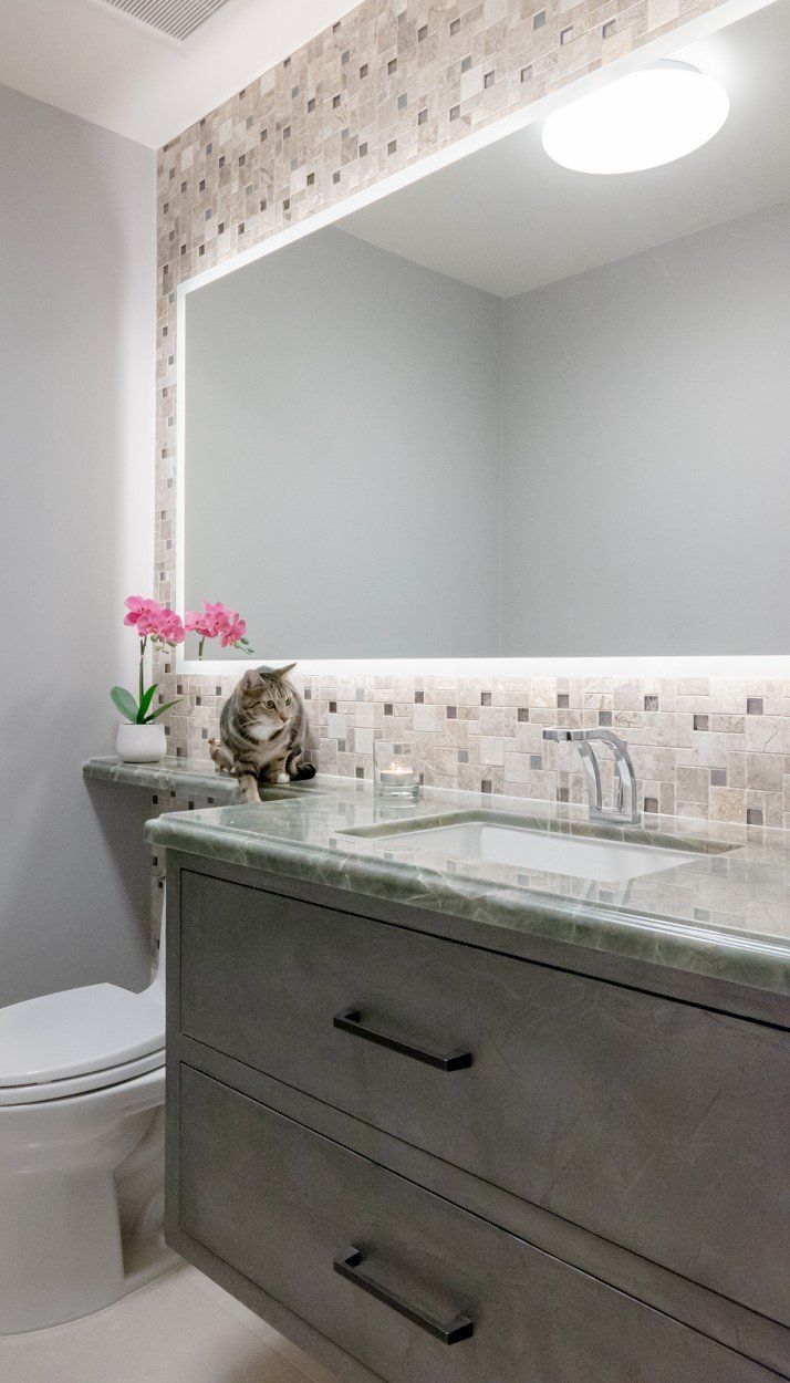 Powder room with a green marble vanity top and mosaic tile backsplash by Roman Marble Shop