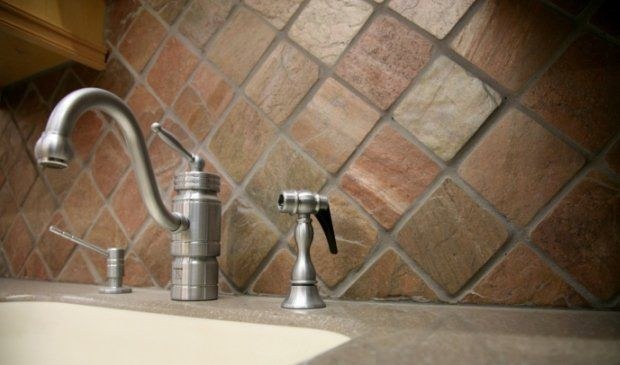 Tumbled stone backsplash, set on the diagonal, by Roman Marble Shop