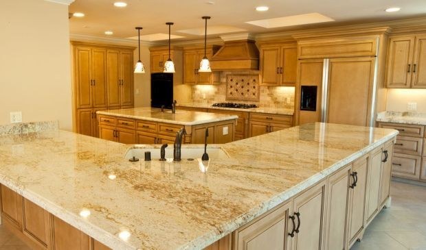 Kitchen with a granite island and travertine floor